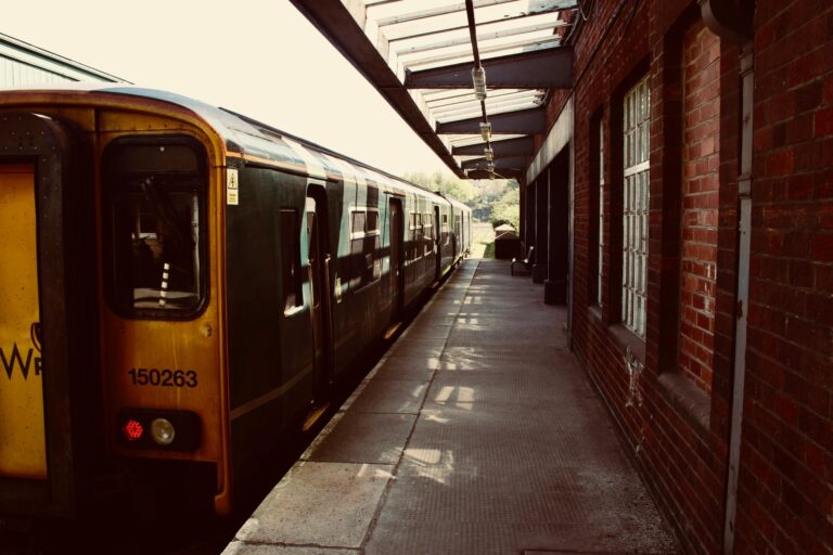 egional passenger train stopped at a station platform in the UK.