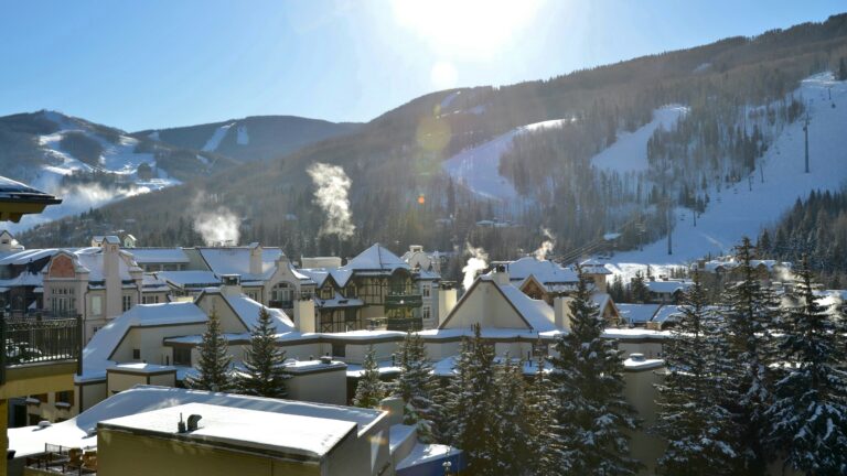 Snow-covered buildings and ski slopes in Vail, Colorado during winter.