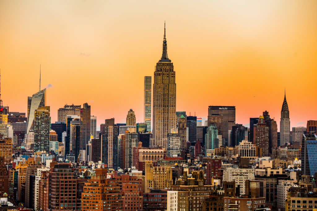 New York City skyline at sunset with the Empire State Building at the centre.