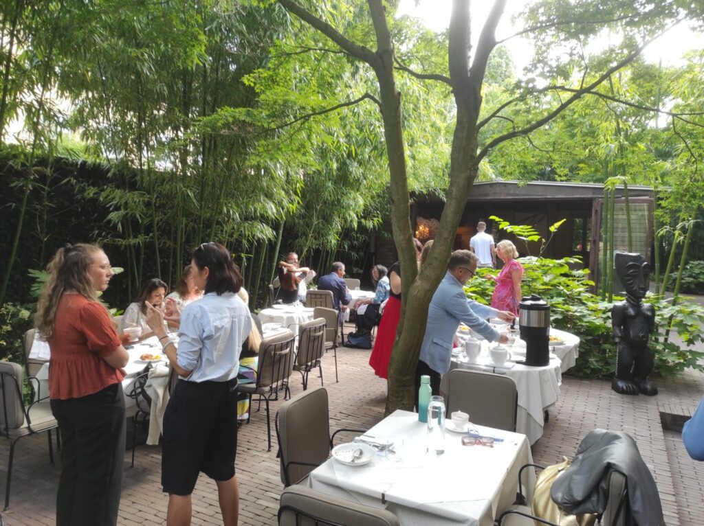 Participants networking at an outdoor breakfast event during the Where Next? launch at London Climate Action Week.